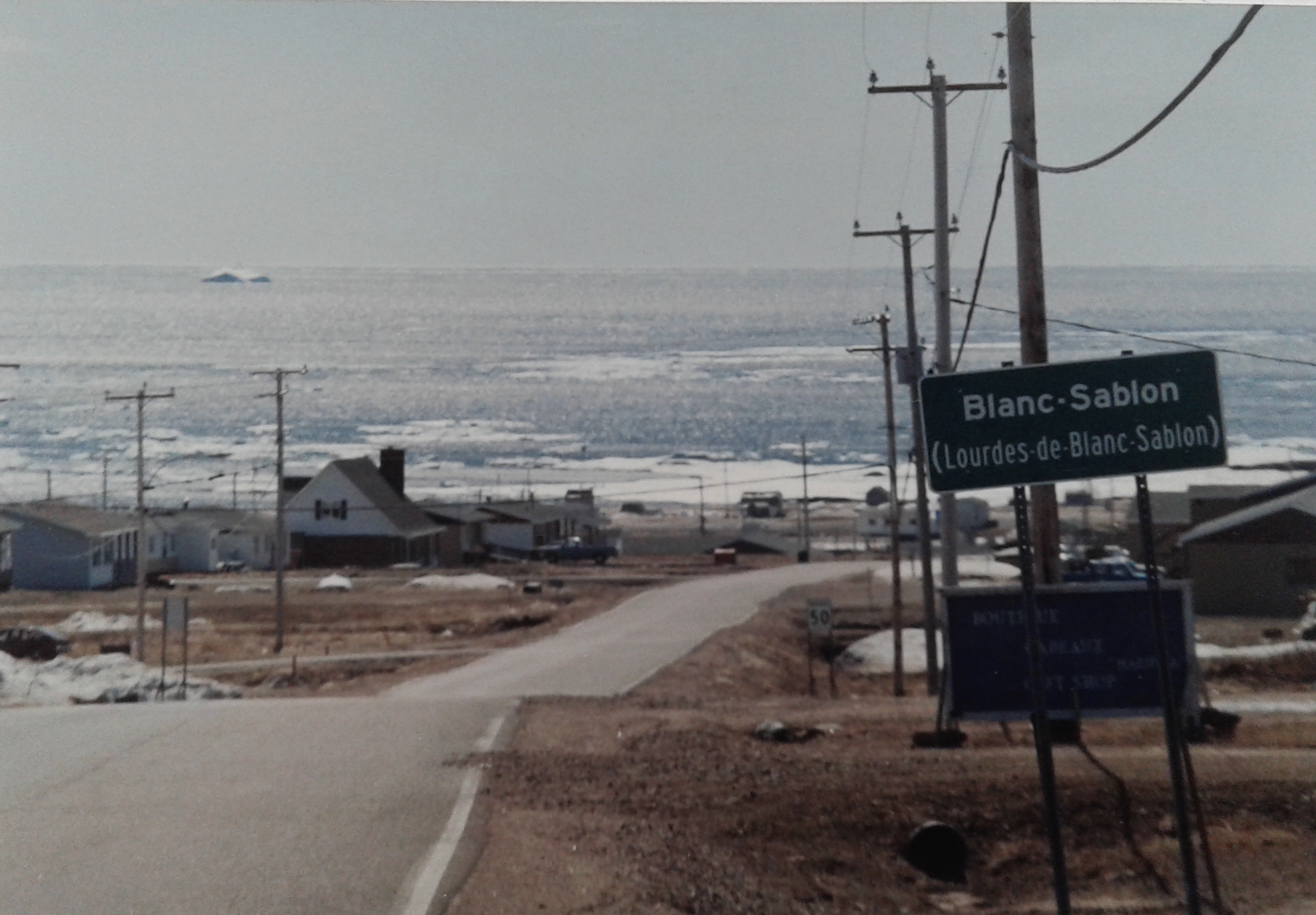 Paved road leading down to Gulf of St. Lawrence in Blanc-Sablon, Quebec
