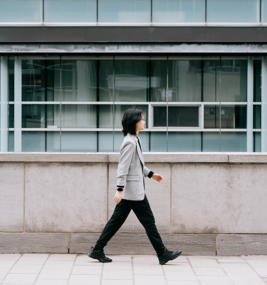 A person walking on a sidewalk