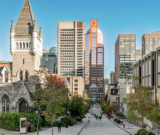 A city with a stone building and tall buildings