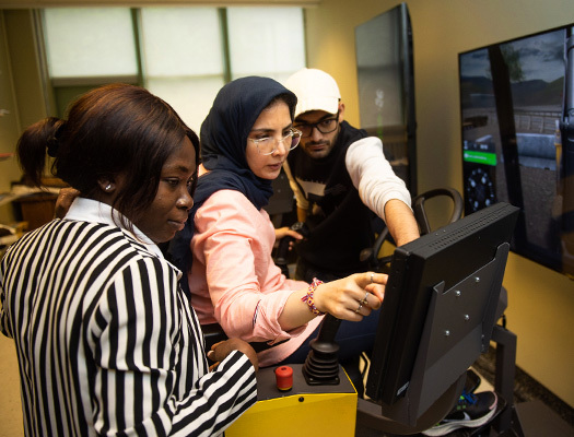 A group of people looking at a computer screen