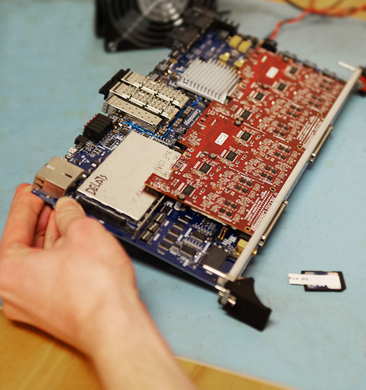 A hand holding a motherboard