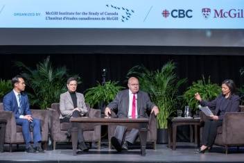 Host and panelists on stage