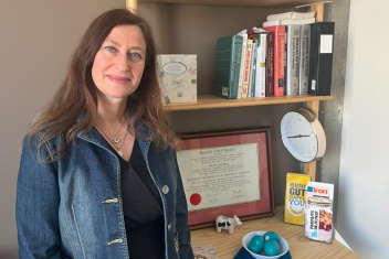 Woman standing near bookcase