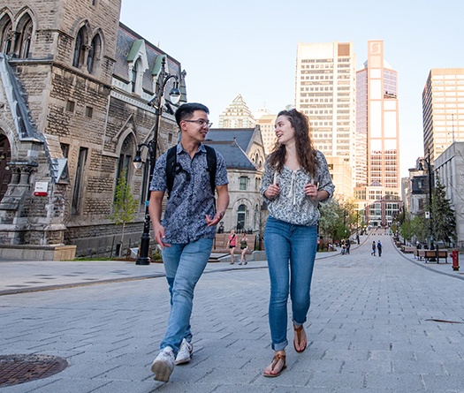 Male and female student walking on McTavish street.