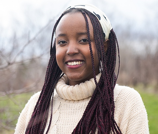 A girl with long braids smiling