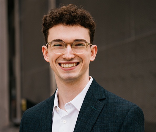 A man wearing glasses and a suit