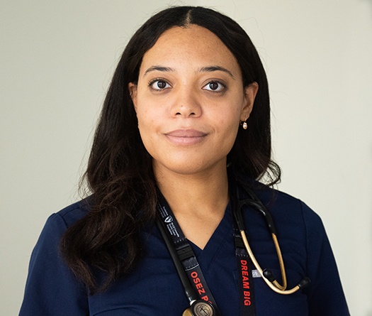 A person wearing a blue shirt with a stethoscope