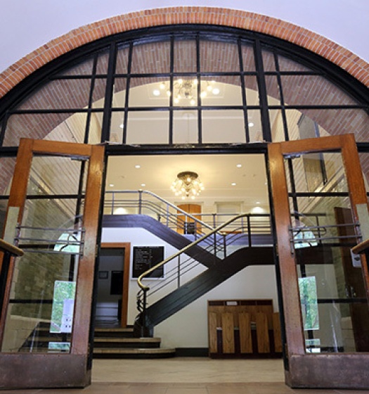 A large glass door with a staircase leading to the entrance