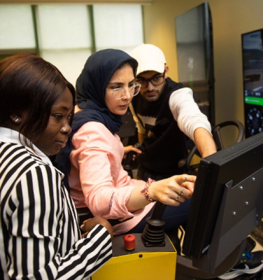 A group of people looking at a computer screen