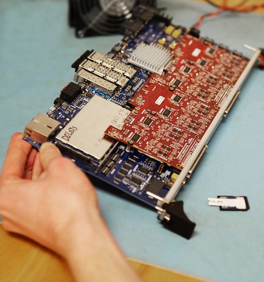 A hand holding a motherboard