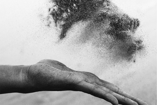 Hand throwing pigment in the air