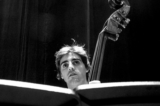 Man playing cello in black and white
